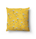 Tsuru Cushion. Japanese Red crownd cranes are scattered across the cushion as if they are walking in different directions. Grey textured dots are layered ontop of a golden yellow backgroun