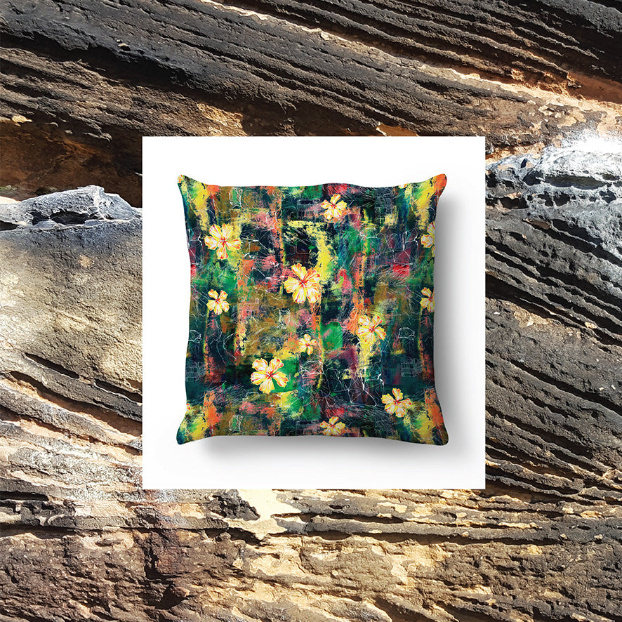 ROCK PAPER FLOWER CUSHION WITH BOULDER IN BACKGROUND