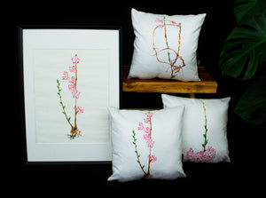 Three sakura cushions desplayed together next to an original hand painted Cherry blossom artwork in an A2 frame.