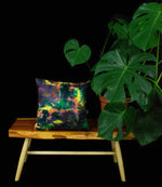 Wild Hearted Cushion displayed ontop of a handmade wooden table next to a cheeseplant and a black backdrop